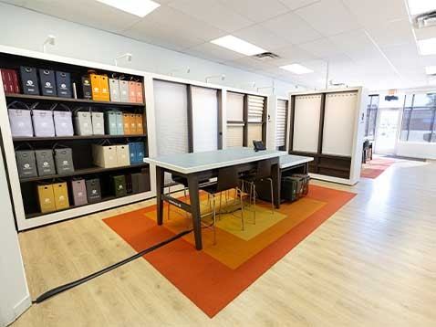 Store interior showcasing several different types of window coverings